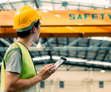 Man with safety helmet in factory